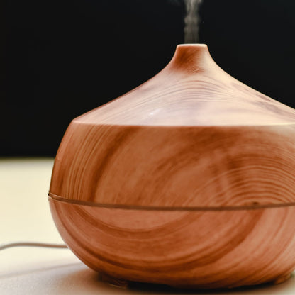 Light wood-grain diffuser releasing a plume of cool mist